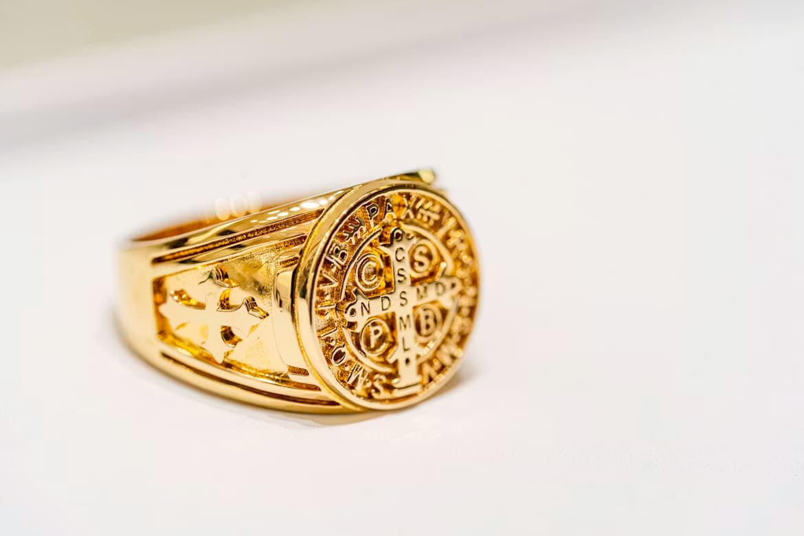 Gold ring displayed on a soft white surface